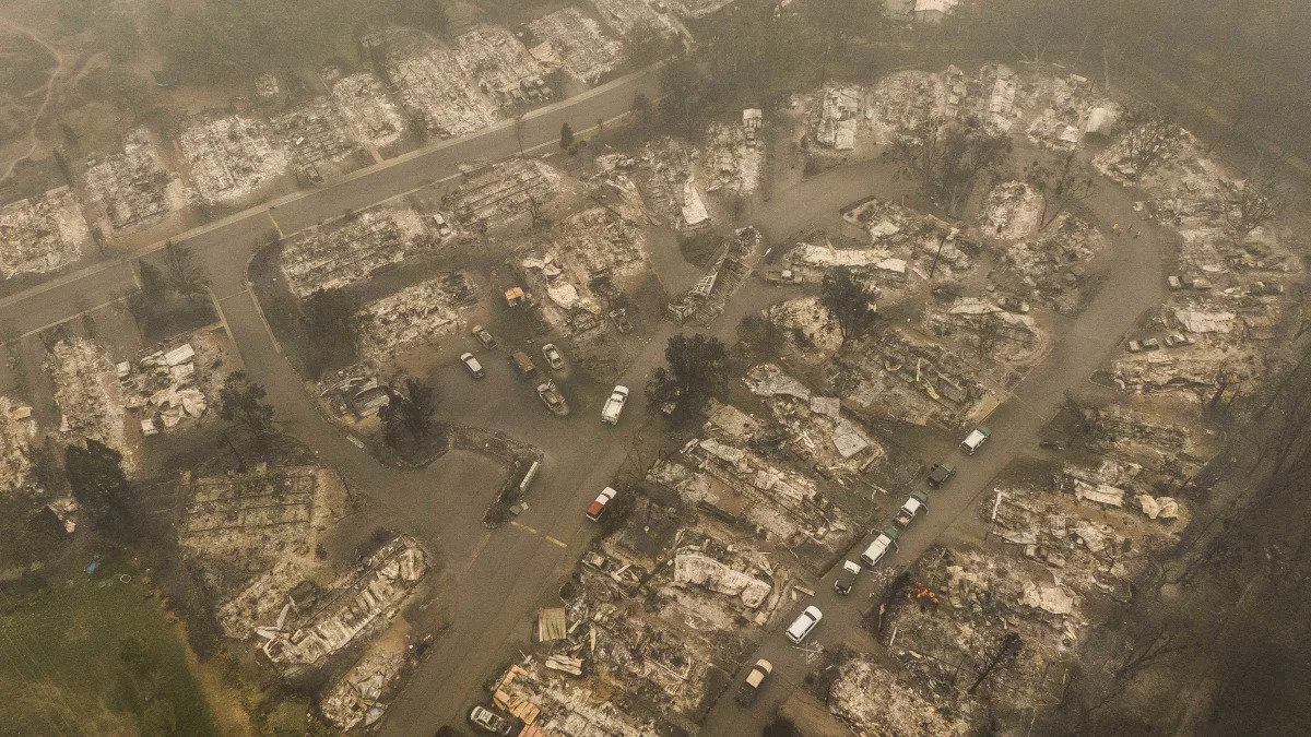 ASHLAND, OR - SEPTEMBER 11: In this aerial view from a drone, search and rescue personnel from the Jackson County Sheriff's Office look for the possible remains of a missing elderly resident in a mobile home park on September 11, 2020 in Ashland, Oregon. Hundreds of homes in Ashland and nearby towns have been lost due to wildfire. (Photo by David Ryder/Getty Images)