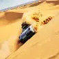 2023 Porsche 911 Dakar in Shade Green sideways on dune