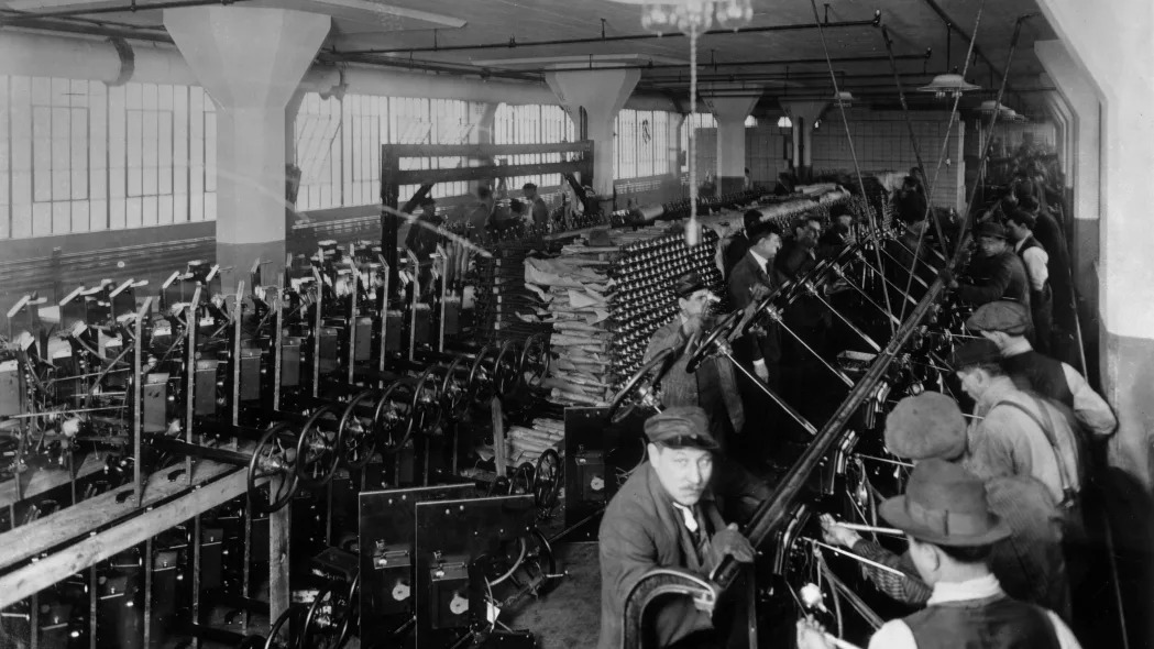 1913: Workers on an assembly line inside the Ford Motor Company factory at Highland Park, Michigan, constructing steering systems.