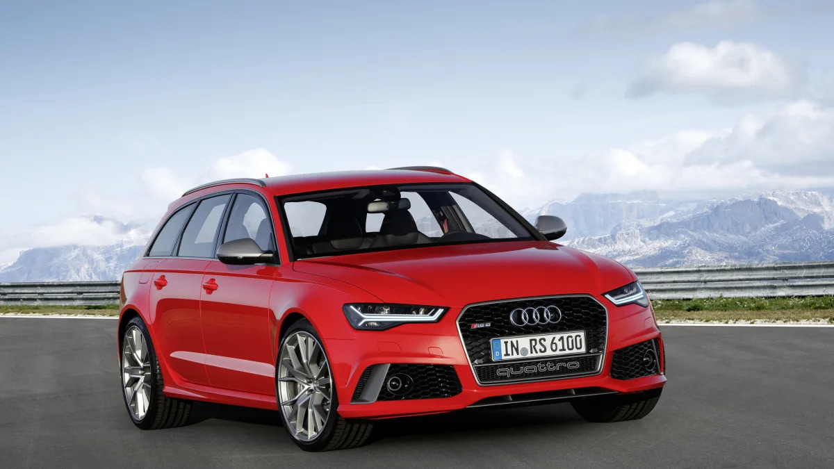 red audi rs6 avant performance front three quarters mountains