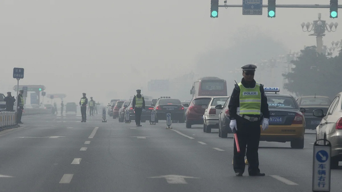 China Environment Vs Economy (In this Thursday, March 7, 2013 Chinese traffic policemen closed off a road for delegation buses attending the annual Chinese People's Political Consultative Conference h