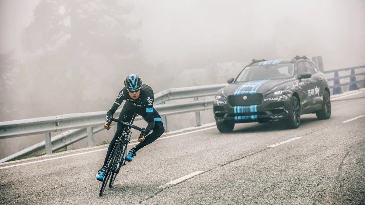 cyclist corner jaguar f-pace background fog