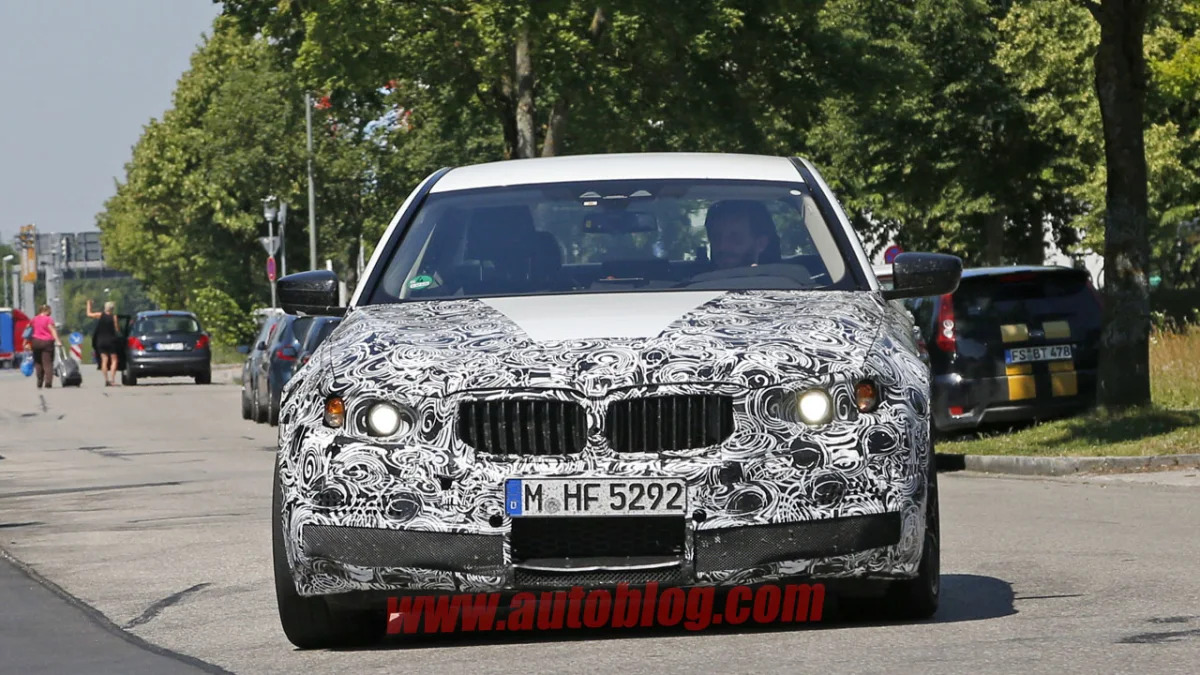 camouflaged bmw m5 spy shots front on