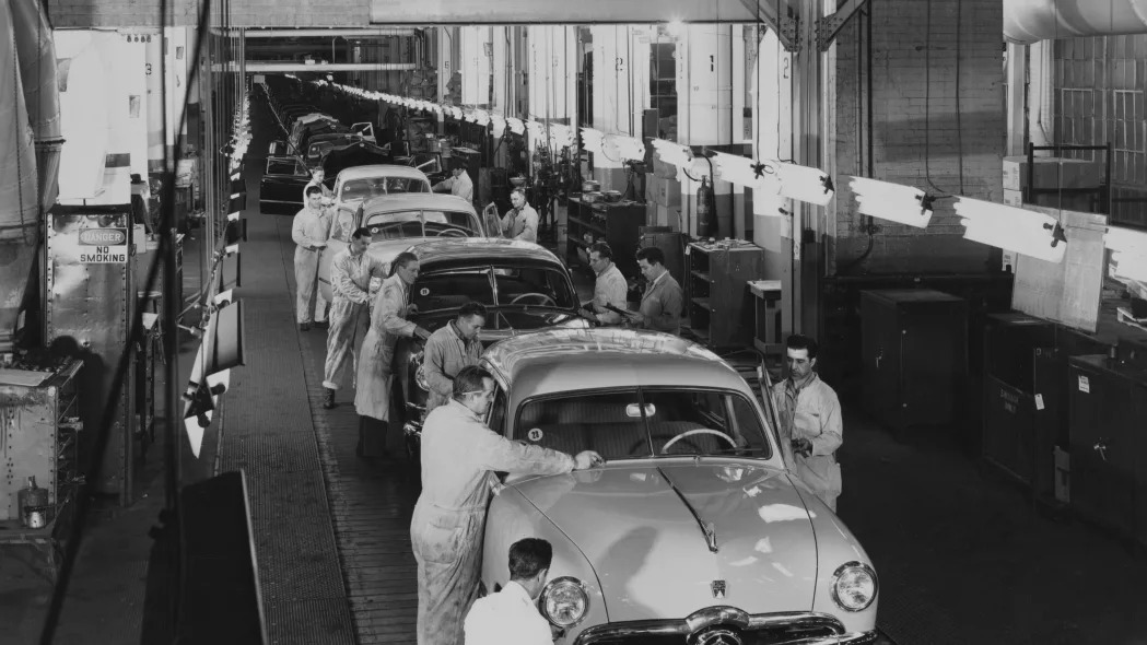 Ford workers put the finishing touches to the Custom Deluxe as they roll off the production line of the Ford assembly plant at Dearborn, Michigan, circa 1950. The vehicles have reached the end of the 1,000-foot assembly line, capable of producing 500 new cars in an eight-hour shift.