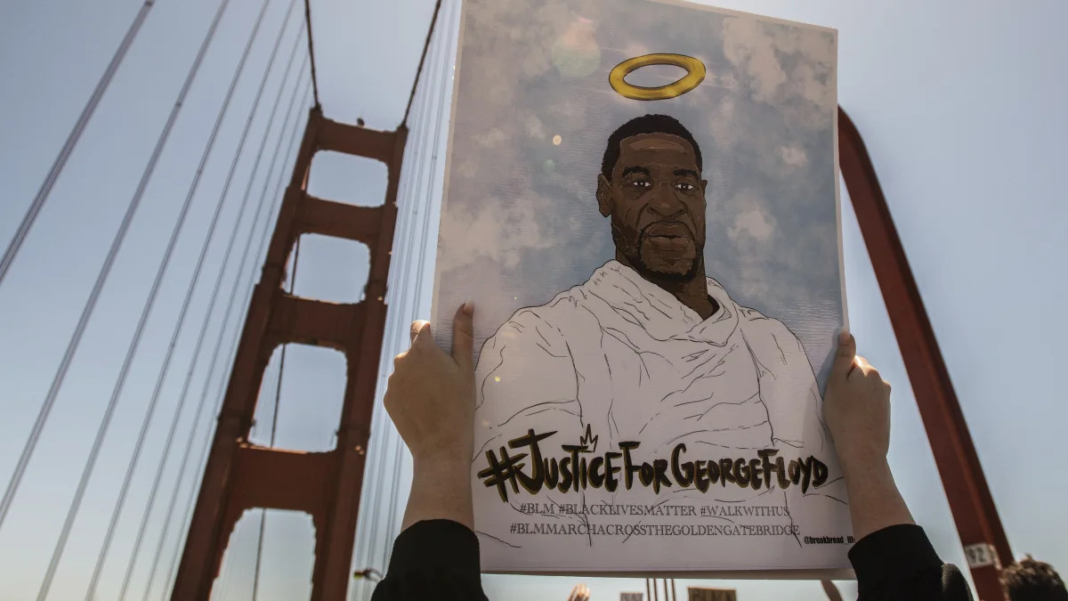 SAN FRANCISCO, CA- JUNE 6: A sign honoring George Floyd is held up on the Golden Gate Bridge in Francisco, California on June 6, 2020 after the death of George Floyd. Protestors climbed over the rails and demonstrated in the lanes causing a shutdown of South Bound traffic. Credit: Chris Tuite/ImageSPACE/MediaPunch /IPX