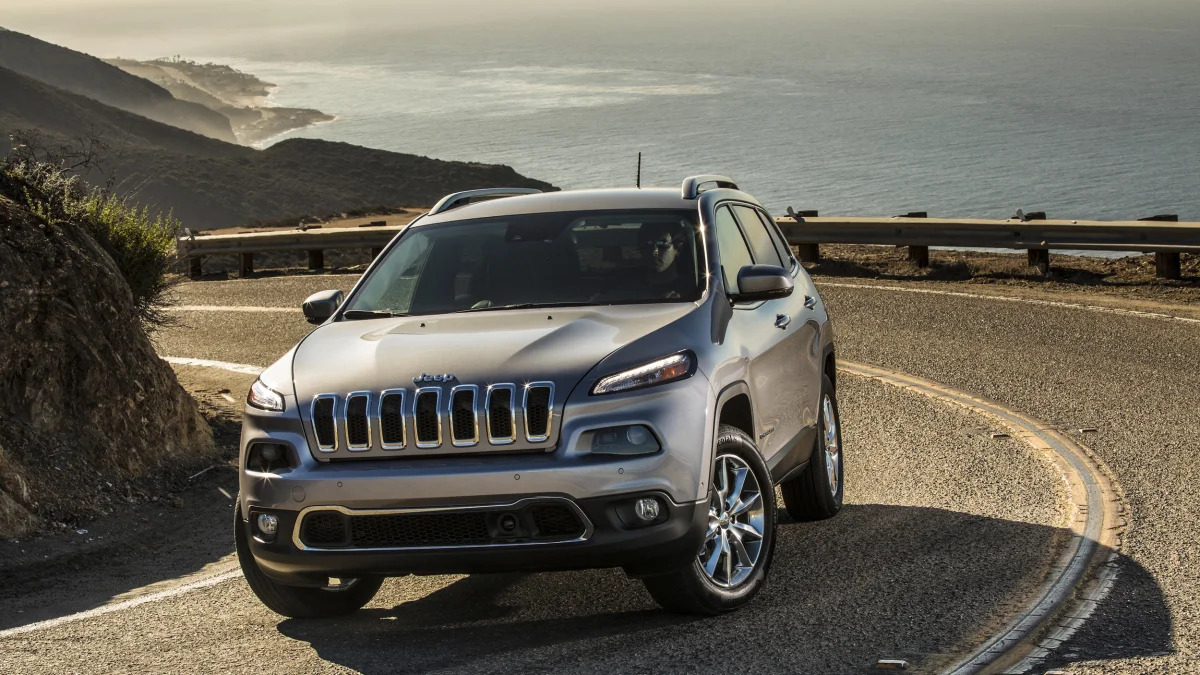 2015 Jeep Cherokee Limited in silver on a winding oceanside road