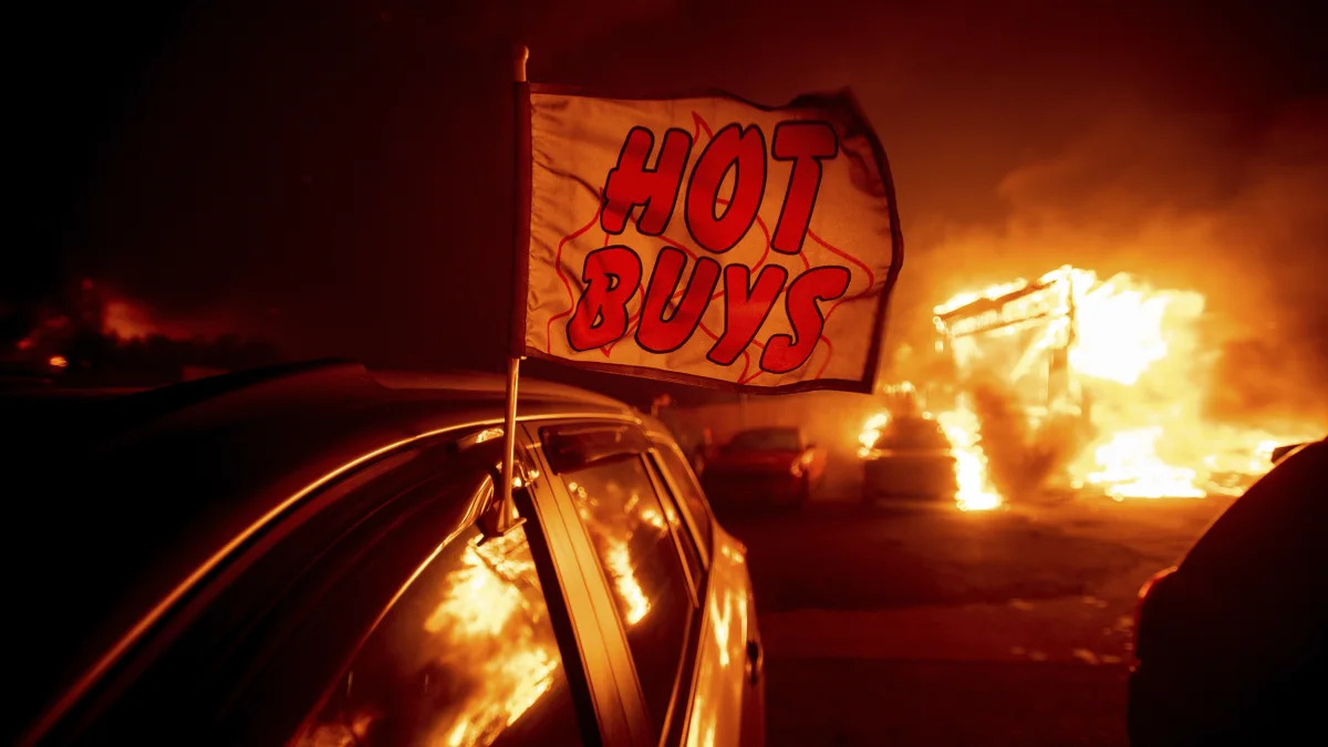 Flames consume a car dealership as the Camp Fire tears through Paradise, Calif., on Thursday, Nov. 8, 2018. Tens of thousands of people fled a fast-moving wildfire Thursday in Northern California, som
