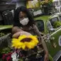 Valcineia Machado, also known as Roberta, poses by her car which she transformed to a mobile flower shop after loosing her business amid the coronavirus disease (COVID-19) outbreak, in Rio de Janeiro, Brazil, October 8, 2020. Picture taken on October 8, 2020. REUTERS/Ricardo Moraes