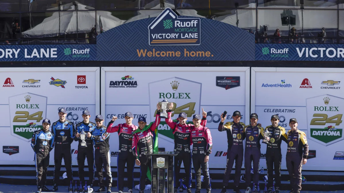 DAYTONA, FL - JANUARY 30:  Helio Castroneves, Oliver Jarvis, Tom Blomqvist, and Simon Pagenaud, drivers of the #60 Meyer Shank Racing w/ Curb-Agajanian Acura DPi, celebrate the podium with Ricky Taylor, Filipe Albuquerque, Alexander Rossi, and Will Stevens, drivers of the #10 Konica Minolta Acura ARX-05 Acura DPi  and Richard Westbrook, Tristan Vautier, Loic Duval, and Ben Keating, drivers of the #5 JDC Miller MotorSports Cadillac DPi of  after the Rolex 24 at Daytona on January 30, 2022 at Daytona International Speedway in Daytona Beach, Fl. (Photo by David Rosenblum/Icon Sportswire via Getty Images)