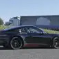 Spy shot of the next-generation 992-model Porsche 911 thought to hide a hybrid powertrain, side. The white plug is the charging port.