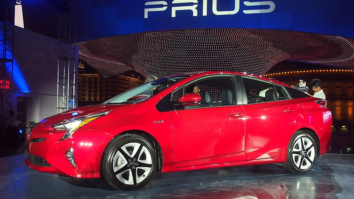 2016 Toyota Prius red, at reveal event, front side profilt
