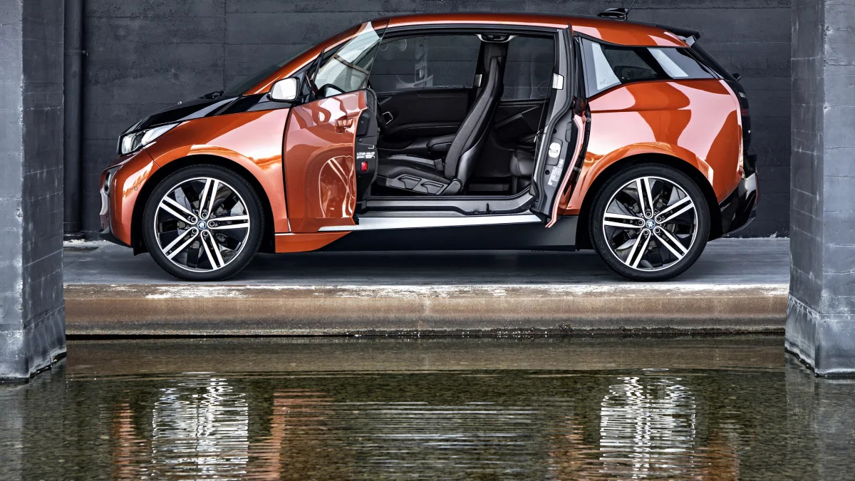 BMW i3 hatchback in orange with its reflection in water