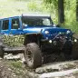 Project Trail Force 2015 Jeep Wrangler Rubicon navigating a trail.