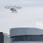 The volocopter, an electrically powered drone taxi, flies near the Mercedes-Benz museum in Stuttgart, southern Germany, on September 14, 2019. - According to the manufacturer it is the first public flight of the Volocopter in a European city. (Photo by THOMAS KIENZLE / AFP)        (Photo credit should read THOMAS KIENZLE/AFP/Getty Images)