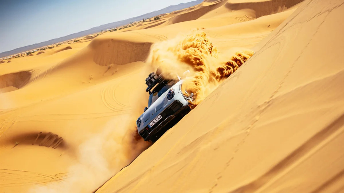 2023 Porsche 911 Dakar in Shade Green sideways on dune
