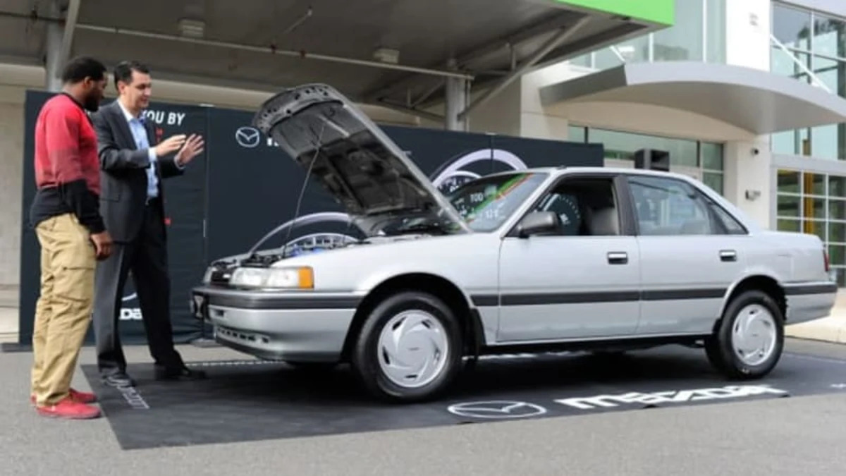 NFL player Alfred Morris receives his thoroughly restored 1991 Mazda 626