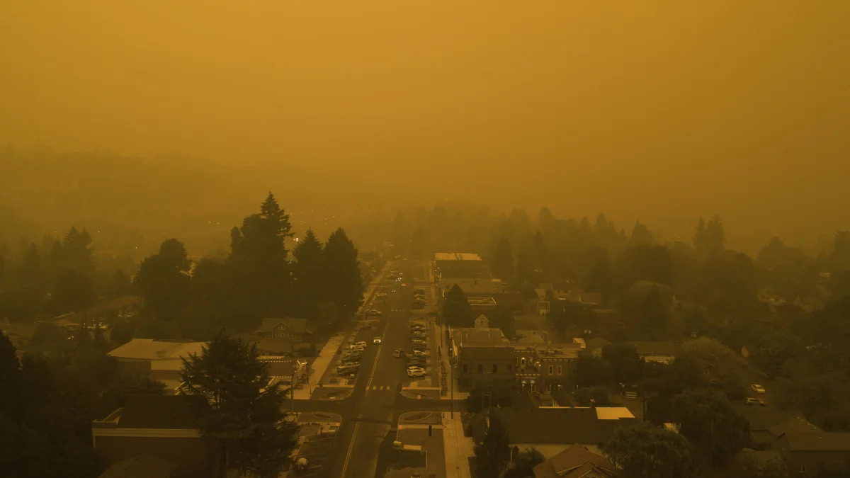 Smoke from widlfires shrouds the town of West Linn, Ore., in this Christian Gallagher drone photo taken around 6 p.m. Thursday, Sept. 10, 2020. (Christian Gallagher via AP)