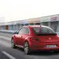 2012 Volkswagen Beetle in red, rear exterior in motion