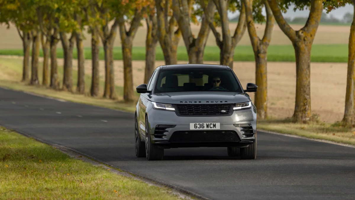 2024 Range Rover Velar action front with some trees