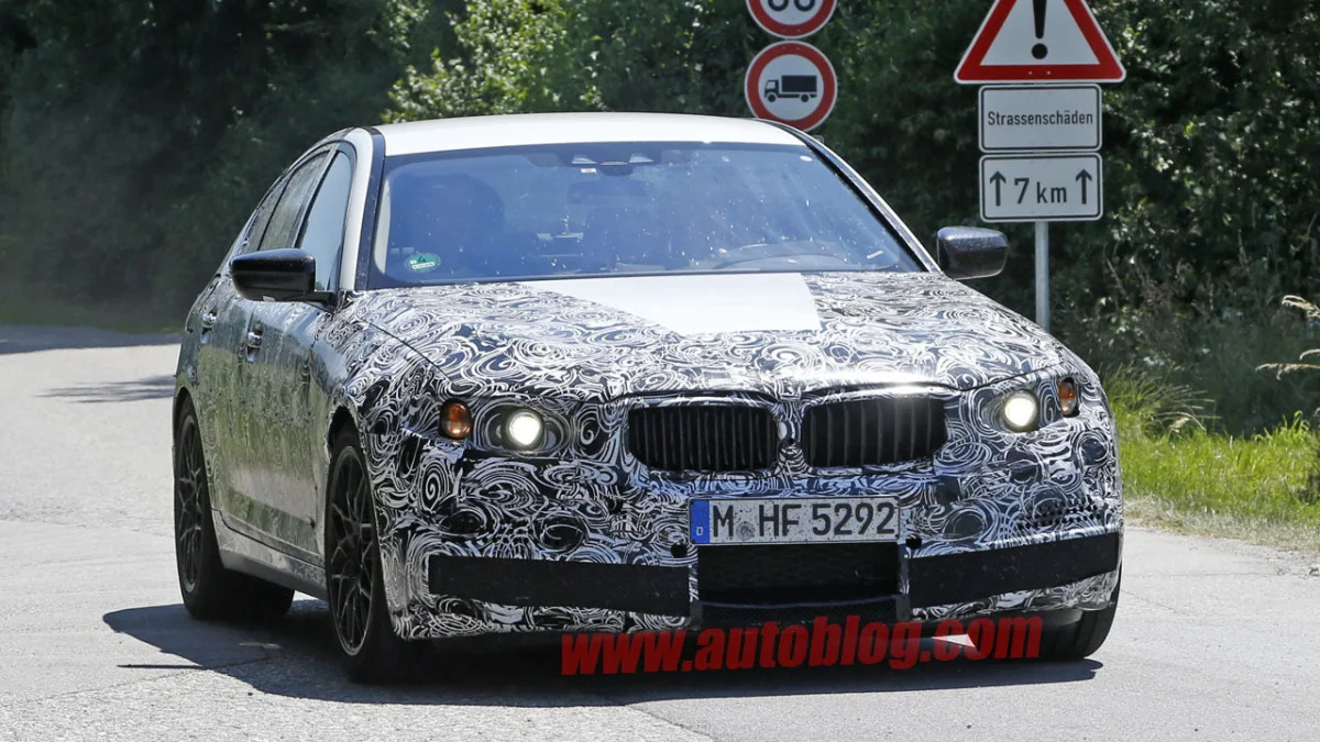 camouflaged bmw m5 spy shots front