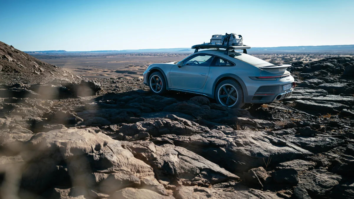2023 Porsche 911 Dakar in Shade Green rear three quarter on basalt