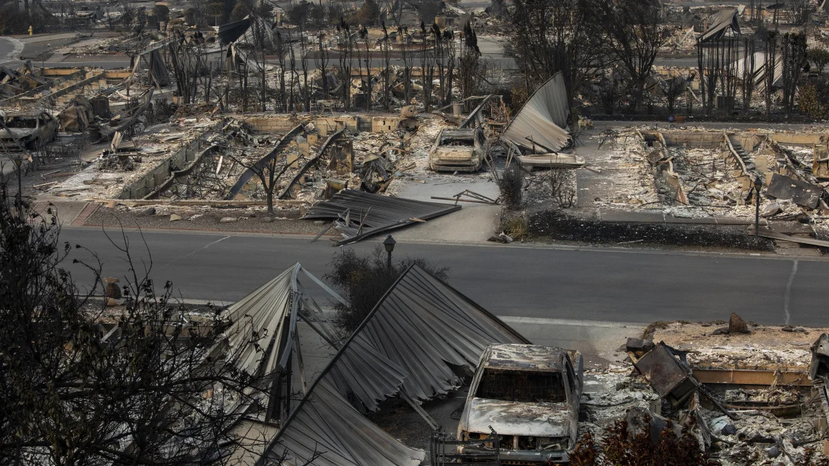 A neighborhood destroyed by fire is seen as wildfires devastate the region, Thursday Sept. 10, 2020 in Talent, Ore. (AP Photo/Paula Bronstein)