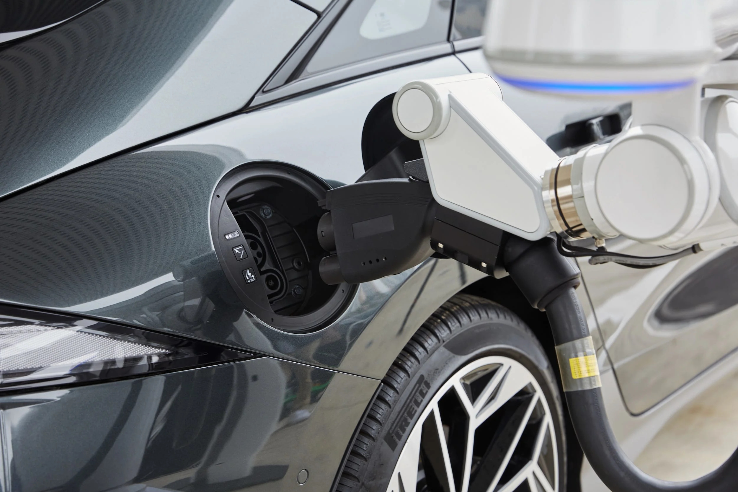 Hyundai's automatic charging robot inserts a charging plug into the Ioniq 6 sedan.