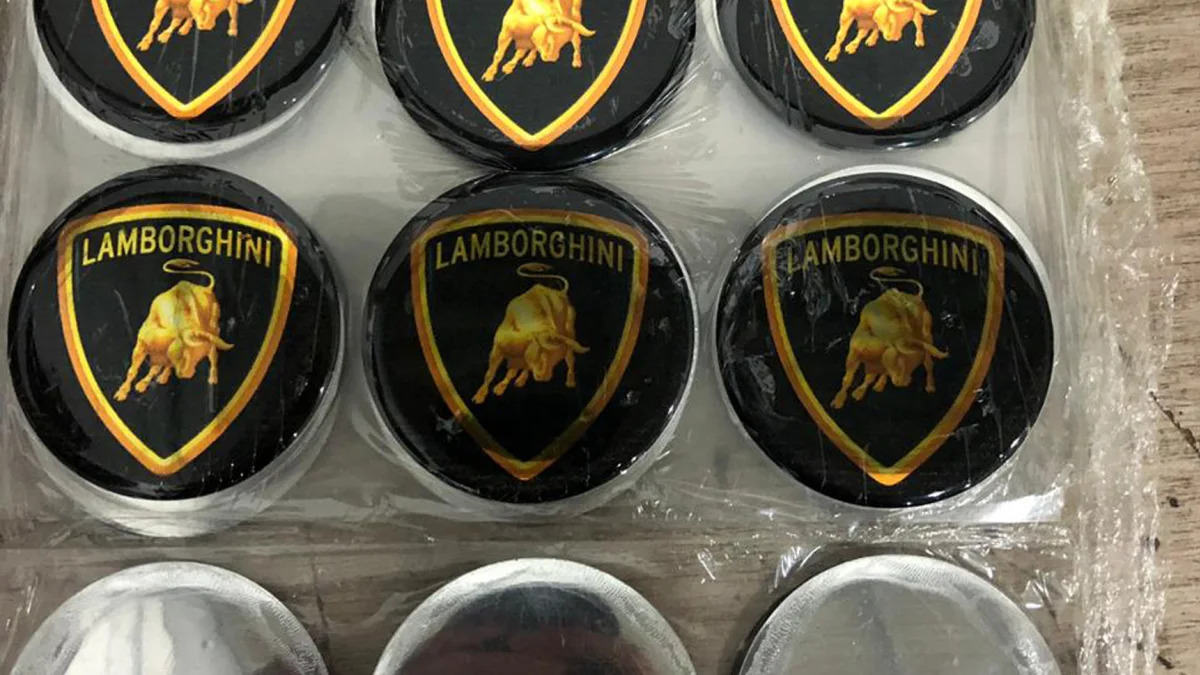 This July 15, 2019 photo released by Itajai Civil Police shows emblem badges stamped with the Lamborghini logo, inside a workshop in Itajai, Brazil. Brazilian police dismantled the clandestine workshop run by a father and son who assembled fake Ferraris and Lamborghinis, in Brazil's southern state of Santa Catarina. (Itajai Civil Police via AP) (Itajai Civil Police via AP)