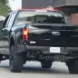 black 2017 ford f-150 raptor spy shot crew cab profile rear with exhaust