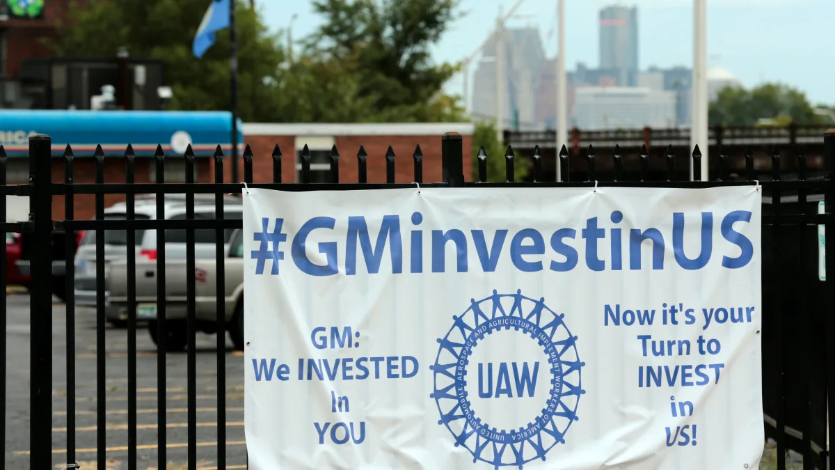 A sign hangs on the fence outside of United Auto Workers (UAW) Local 22 that wants General Motors to invest in them on September 15, 2019 in Detroit, Michigan. - Local UAW leaders from across the nation met Sunday morning in Detroit after the 2015 General Motors collective bargaining agreement expired Saturday night and opted to strike at midnight on Sunday. (Photo by JEFF KOWALSKY / AFP)        (Photo credit should read JEFF KOWALSKY/AFP/Getty Images)